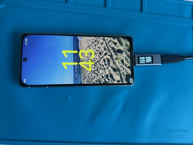 Telefon podłączony do miernika USB podczas testu ładowania